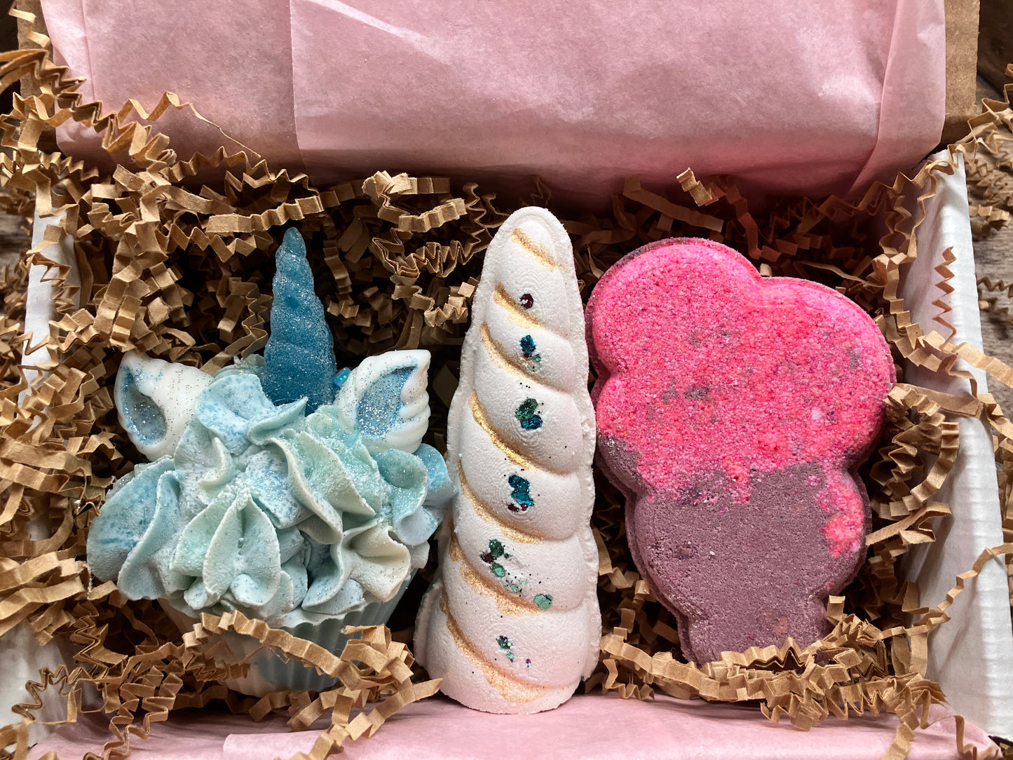 Magical Unicorn Bath Gift Set comes with Magical Unicorn Soap Cupcake, unicorn horn bath bomb, and hot pink and purple cloud bath bomb.