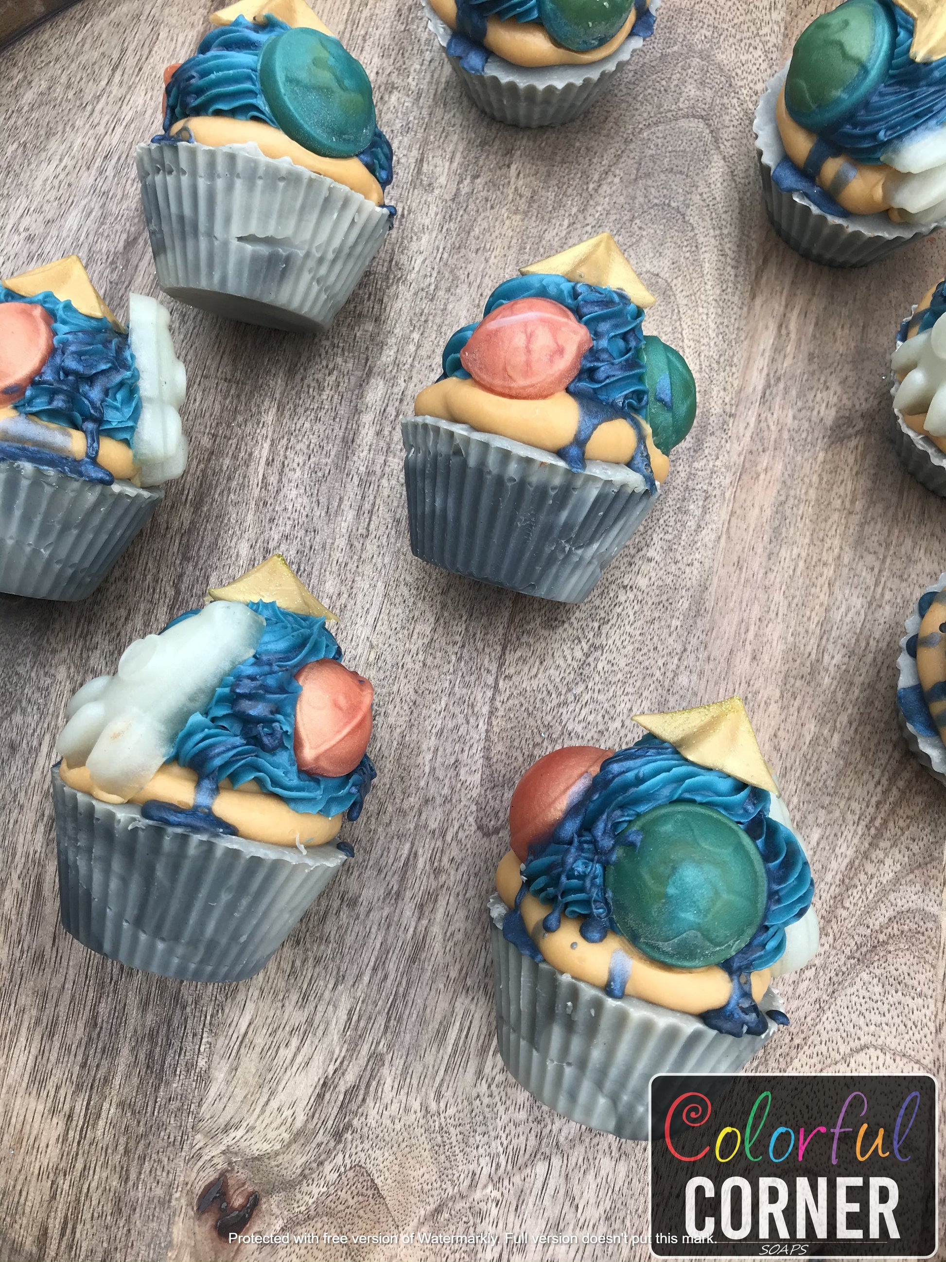 Zoomed out look of cupcake soaps laying on their sides from a different angle.