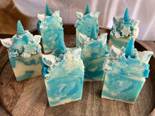 Load image into Gallery viewer, Snowflake the Magical Unicorn 7 Bars displaying all their unique swirls, snowflake sides and glitter tops. Love the frosted horns on this beautiful soap baby.
