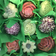 Load image into Gallery viewer, Zoomed in picture of nine soaps in checkered pattern. Top to bottom left to right: Molded Morning Glory, Molded rose, Green Rose frosted cupcake soap, Lilac frosted cupcake soap, Molded Red Rose Soap, Molded Daisy Soap, and Molded Red Rose. 
