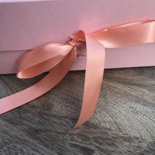 Load image into Gallery viewer, Close up of light pink box ribbon tied in a bow.
