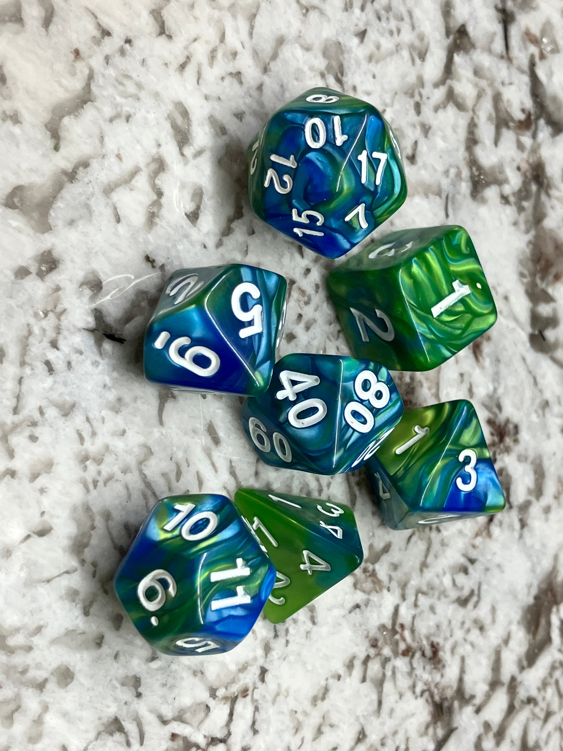 Blue and green dice with white numbers.