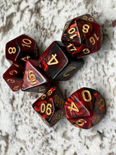 Load image into Gallery viewer, Set of seven dice for role play gaming. Shown in red and black with gold numbering.
