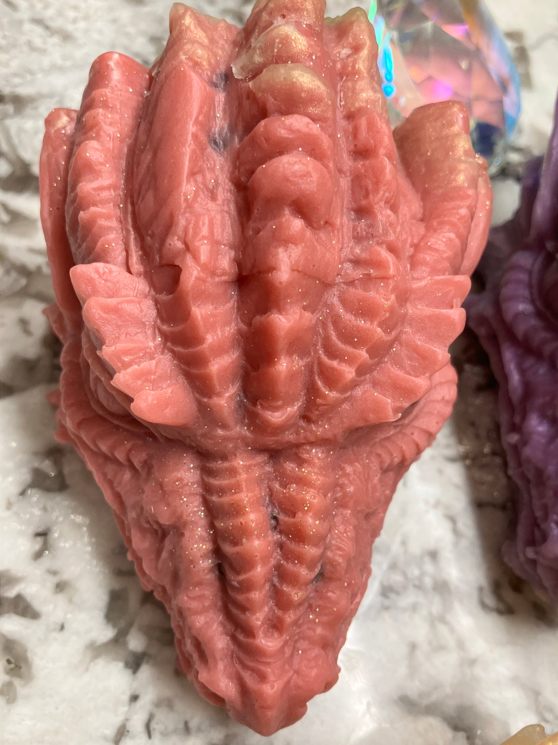 Red colored dragon head soap close up.