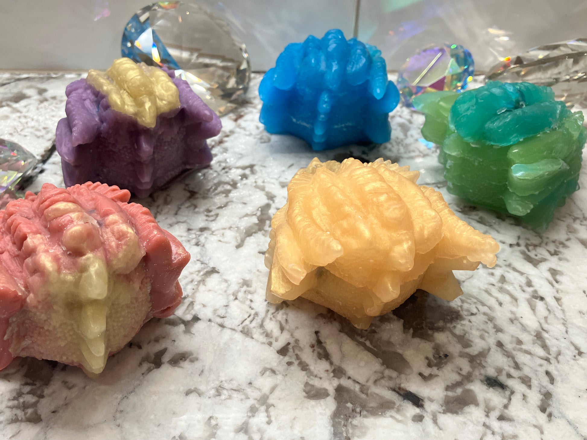 All five dragon head backs shown from left to right: red, purple blue, gold and green.