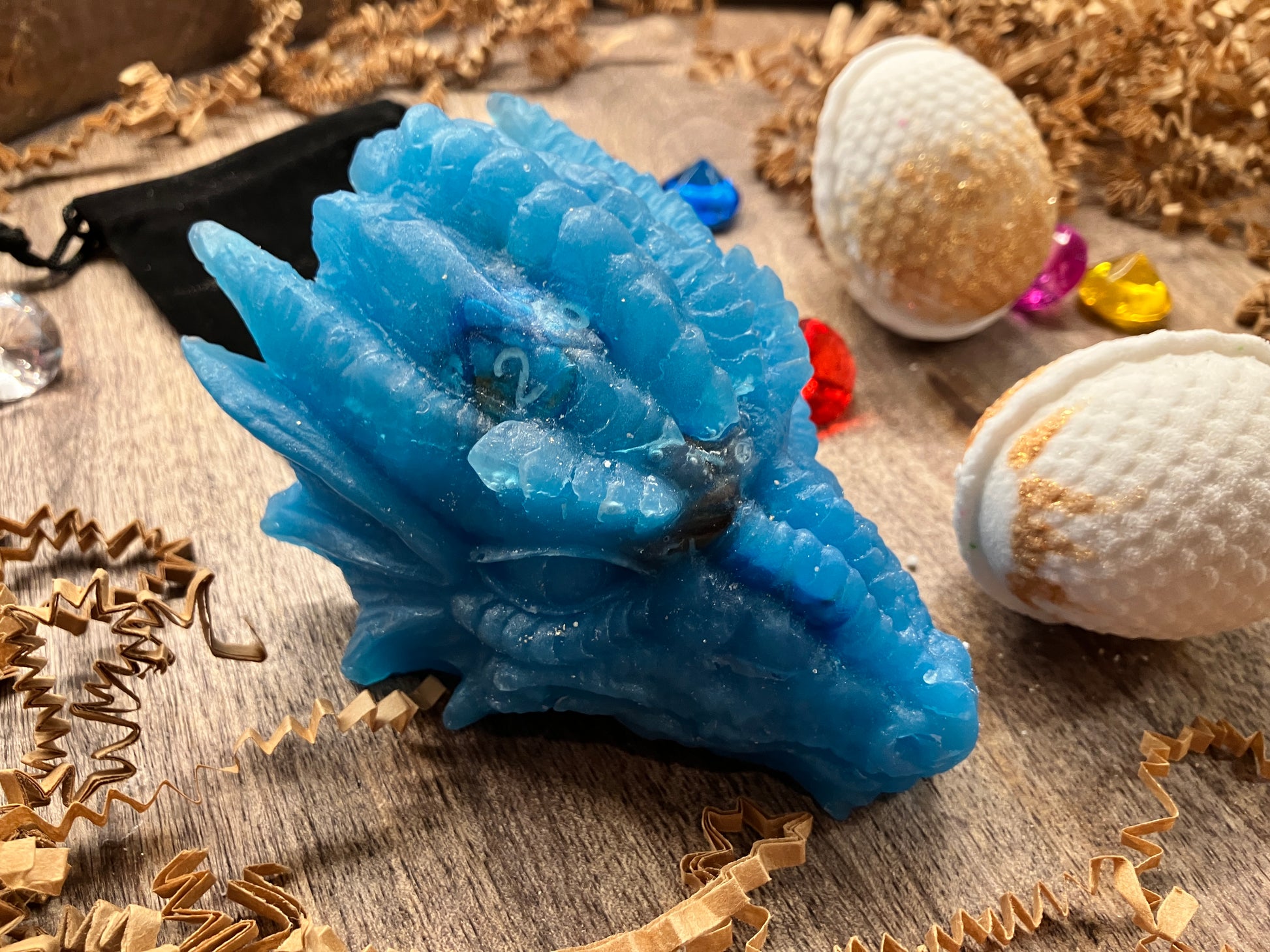 Close up of blue dragon head next to dragon egg bath bombs.